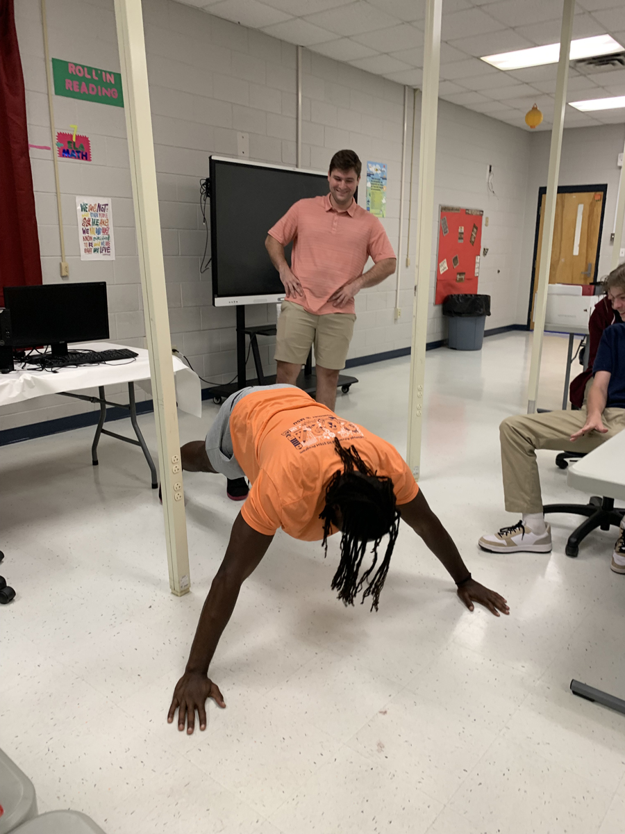 Oso being “programmed” to do a push-up by Riverside HS Computer Science students